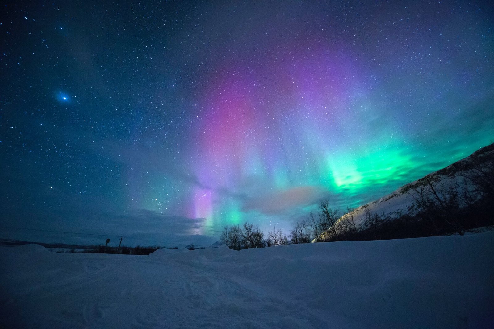 northern lights over snow-capped